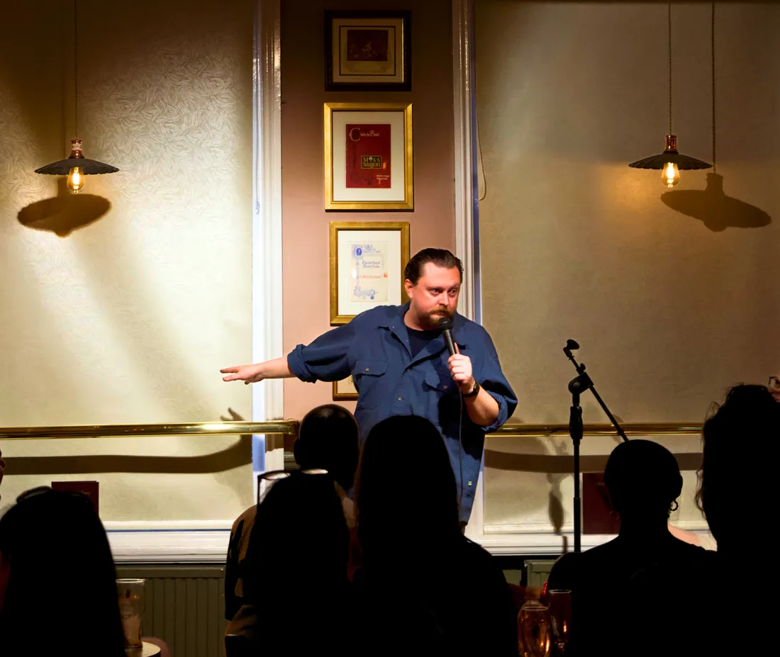Comedian performing live stand-up to the audience at JK Comedy Club Covent Garden, the Nell of Old Drury