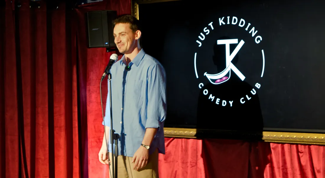 Comedian performing live on stage at JK Comedy Club in London