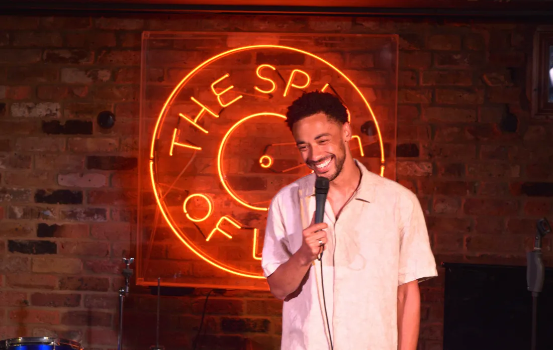 Comedian performing live stand-up on stage at JK Comedy Club Soho